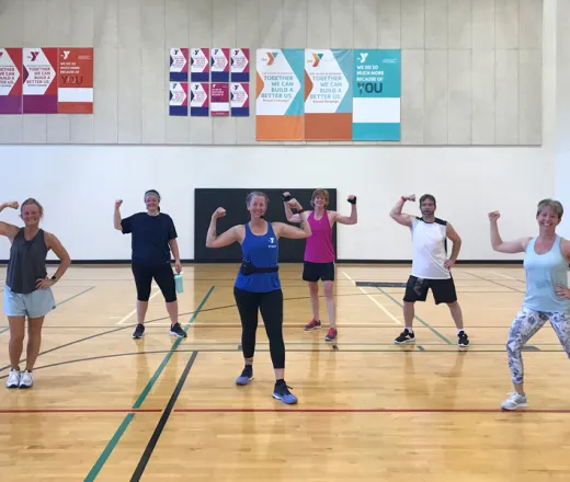 Group of adults muscle with muscles flexed after successful workout.